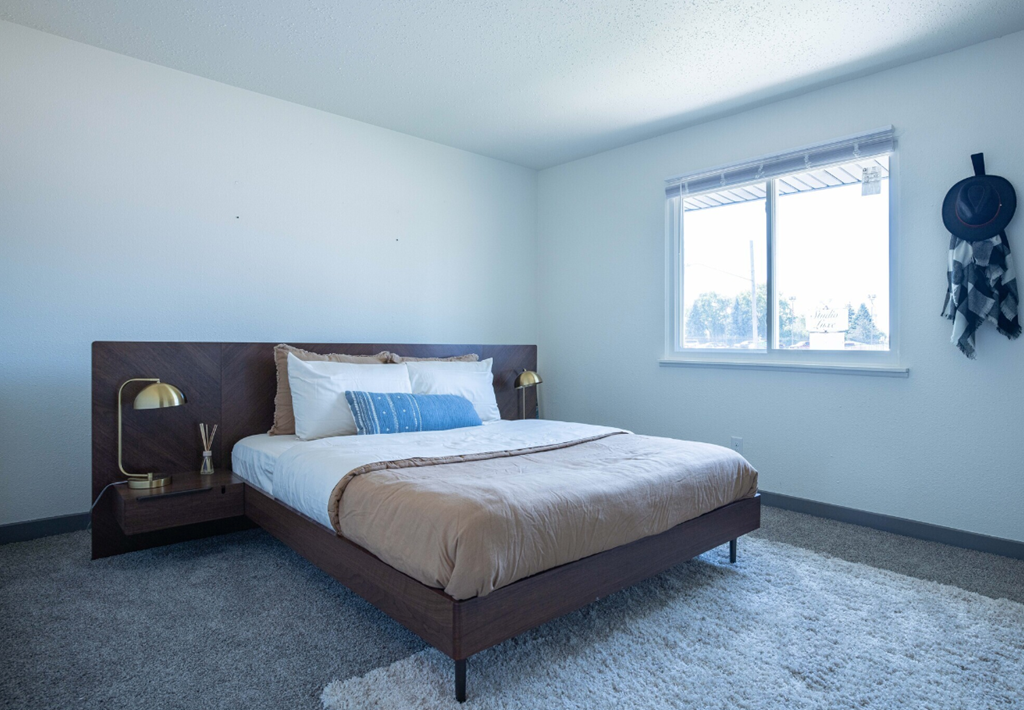 a bedroom with a bed and a window