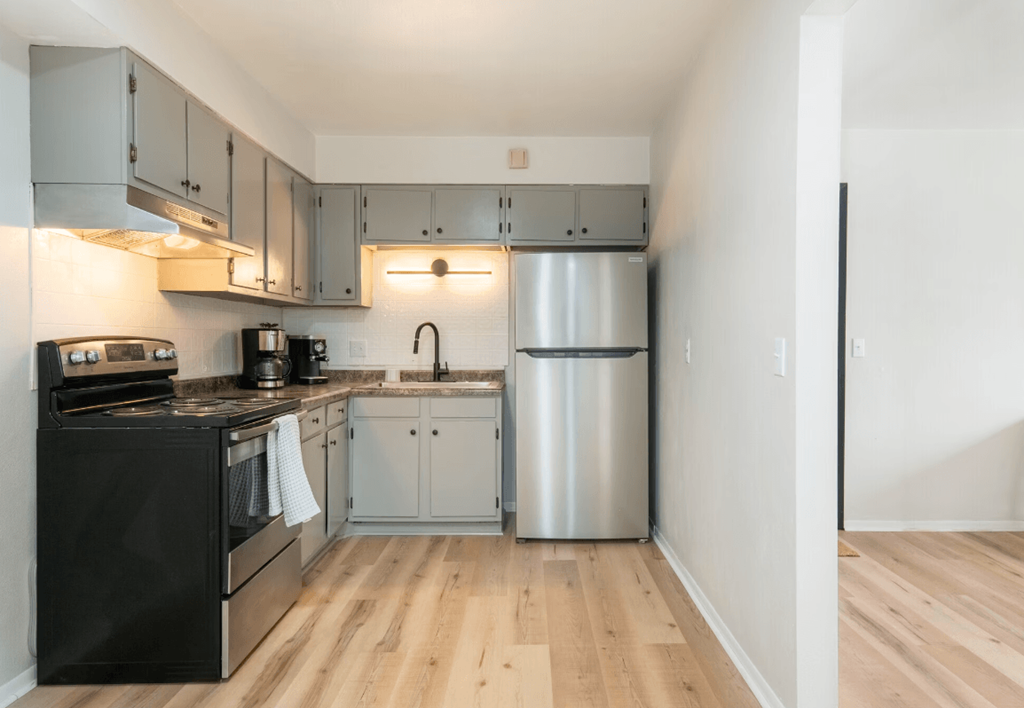 a kitchen with stainless steel appliances and white cabinets