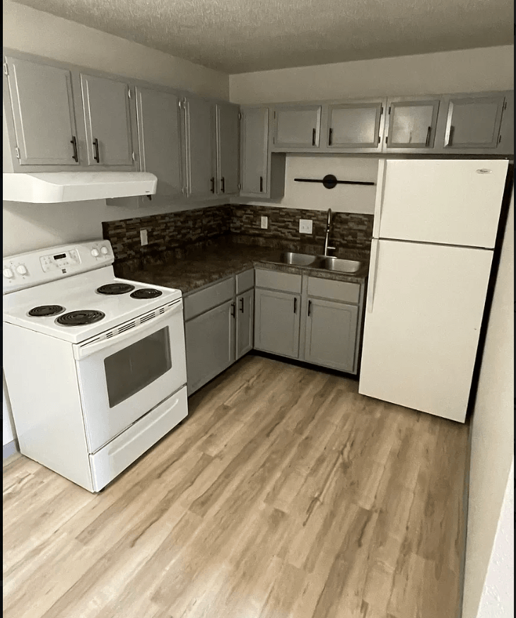 a kitchen with white appliances and white cabinets