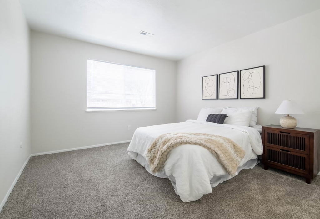 a bedroom with a bed and a window