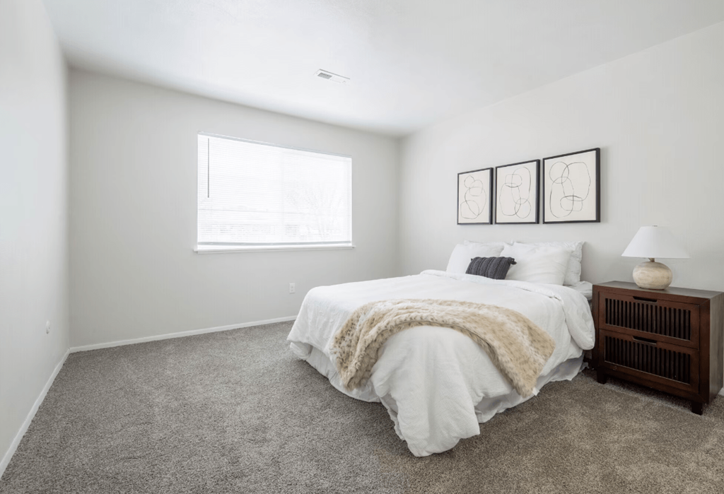 a bedroom with a bed and a window