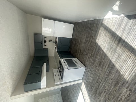 a small kitchen with a stove and a microwave