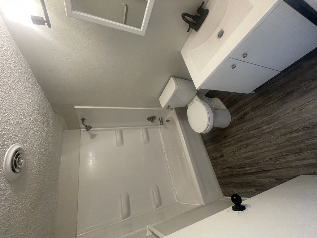 a small bathroom with a shower and toilet in it