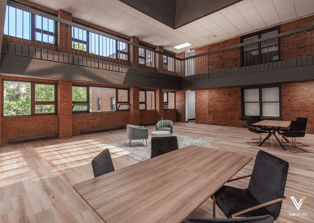 a large room with a wooden table and chairs