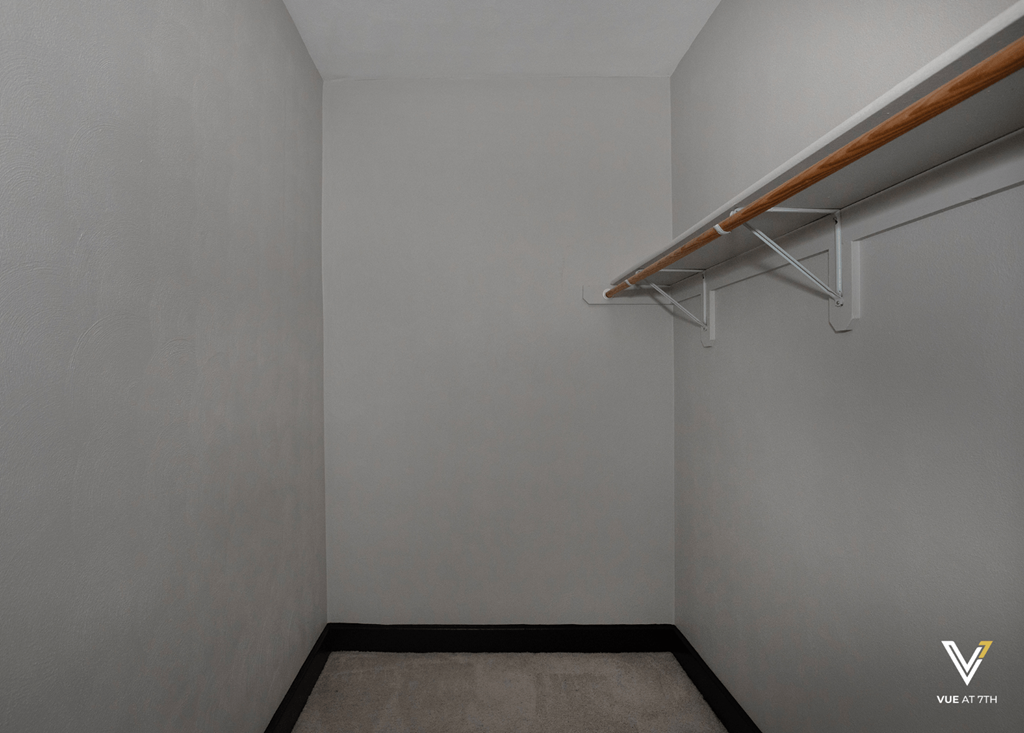 an empty room with a white wall and a white hanger on the wall