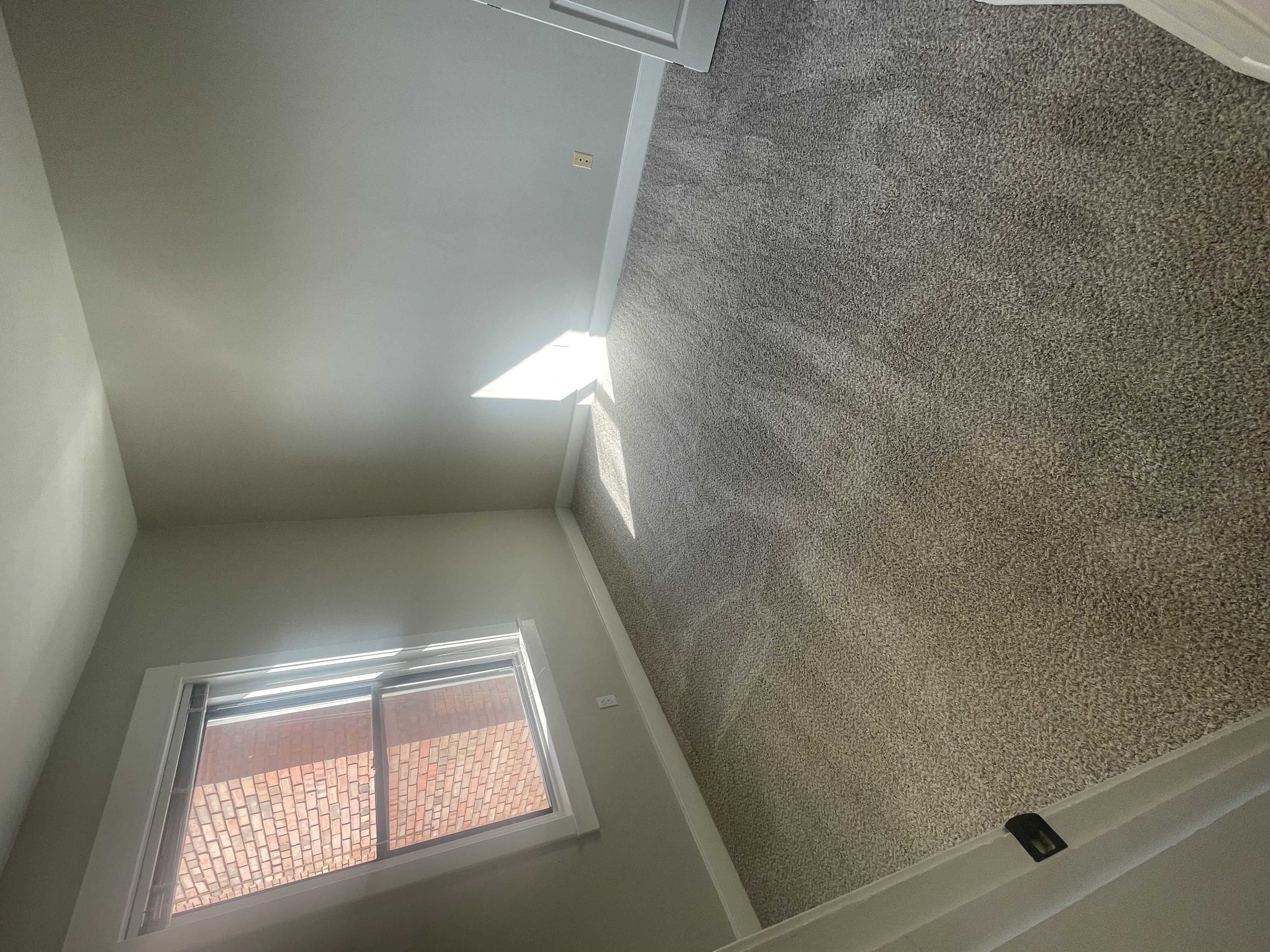 the view from the top of the ceiling looking up at a window