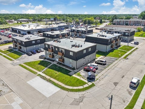 an aerial view of a group of buildings in a parking lot