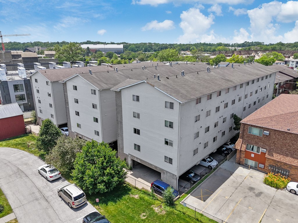 a large white building with cars parked in front of it