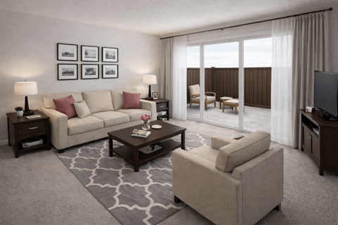 A living room with a white sofa, a coffee table, and a television.