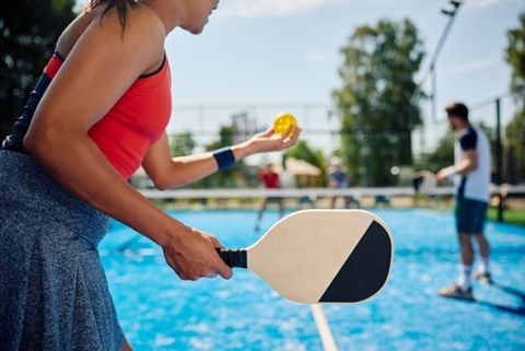 A woman is playing tennis in a pool.