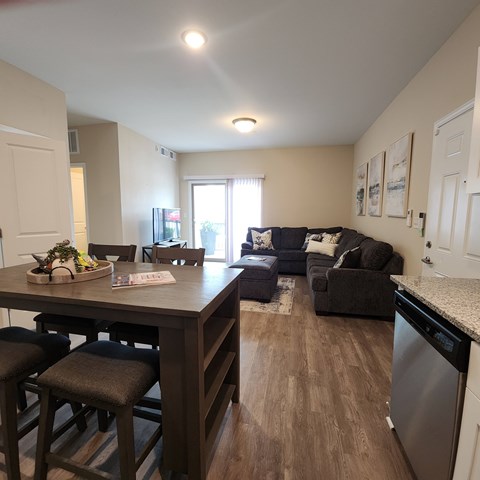 A kitchen with a dining table and chairs.