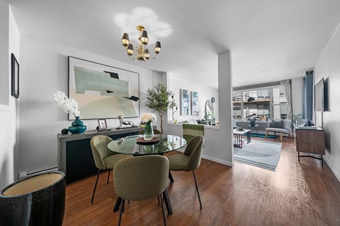 A modern dining room with a wooden table and chairs.