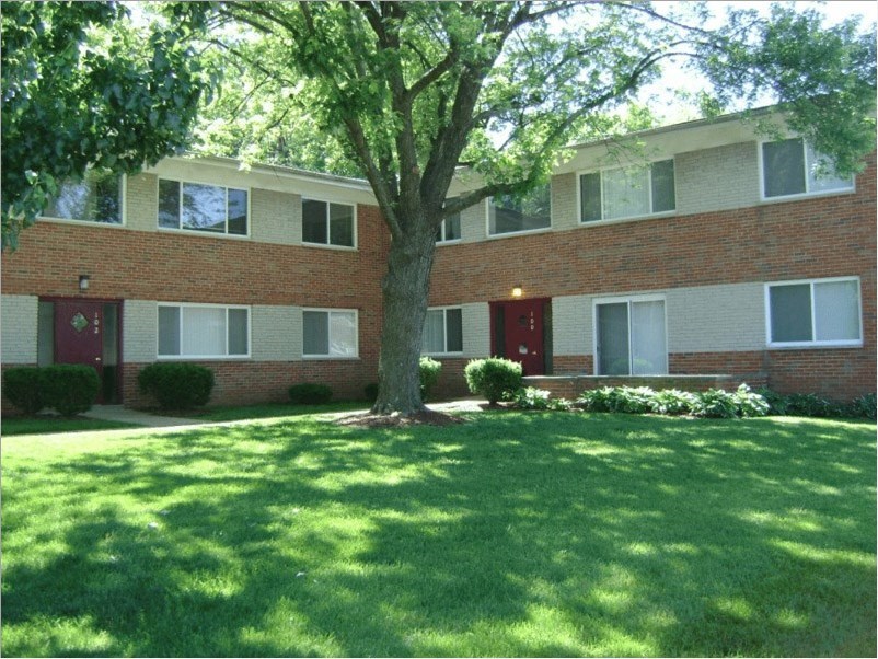 a large brick building with a large tree in front of it