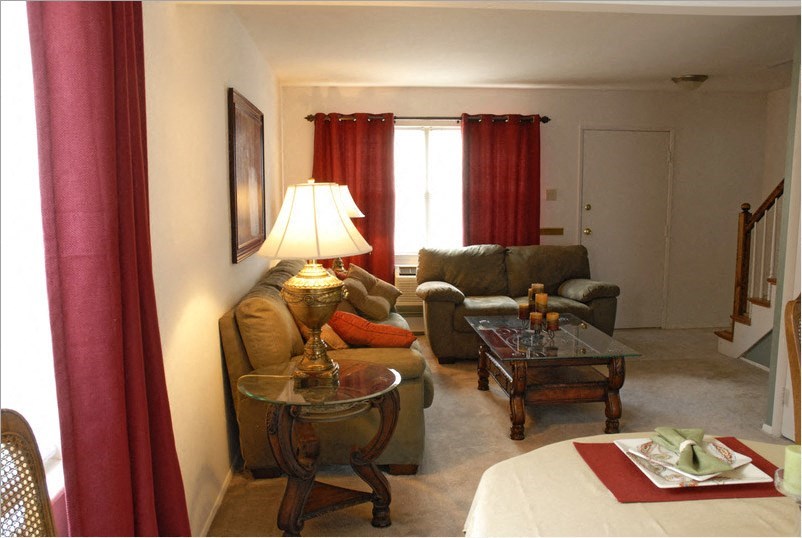 a living room filled with furniture and a table