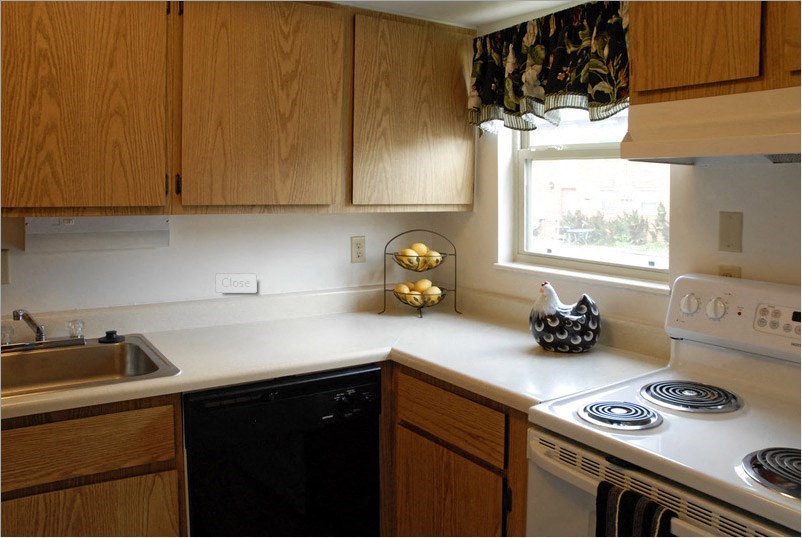 a kitchen with a stove top oven and a sink