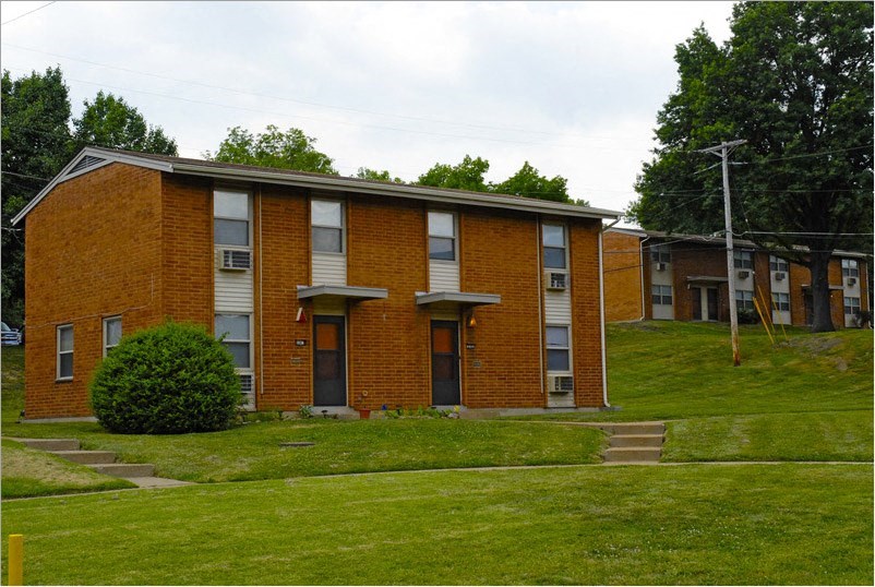 a red brick apartment building on a hill