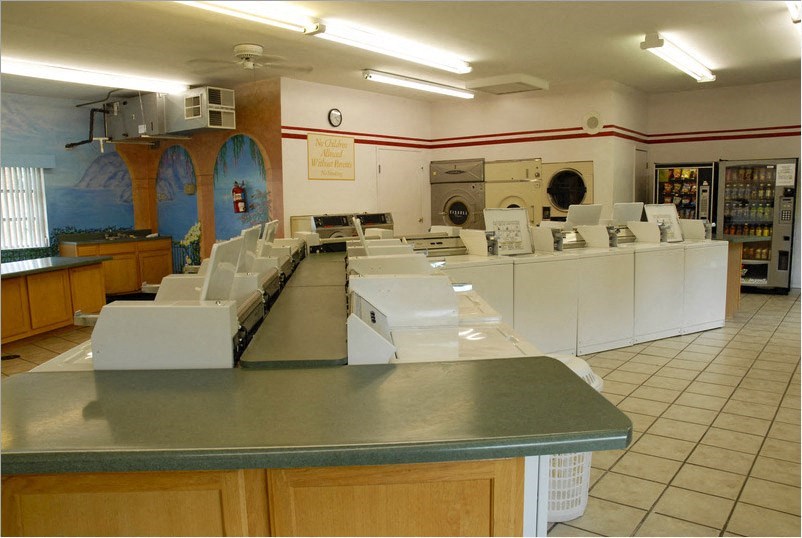 a kitchen with a bunch of counters and appliances