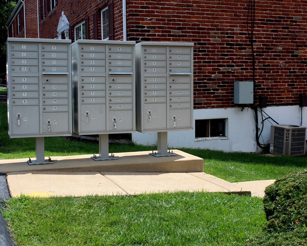 a group of mailboxes in front of a brick building