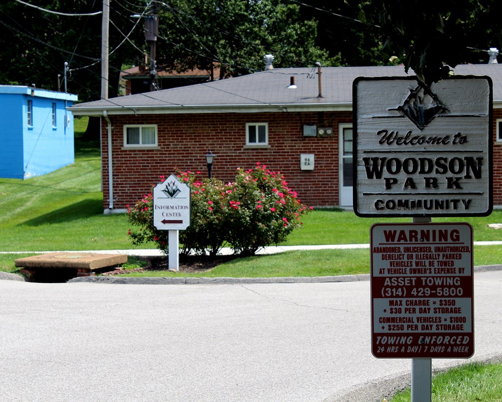 a sign for woodson park in front of a house