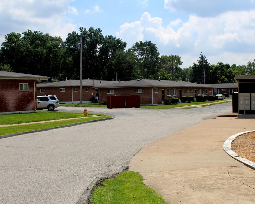 a view of a street in a apartment complex with a red door