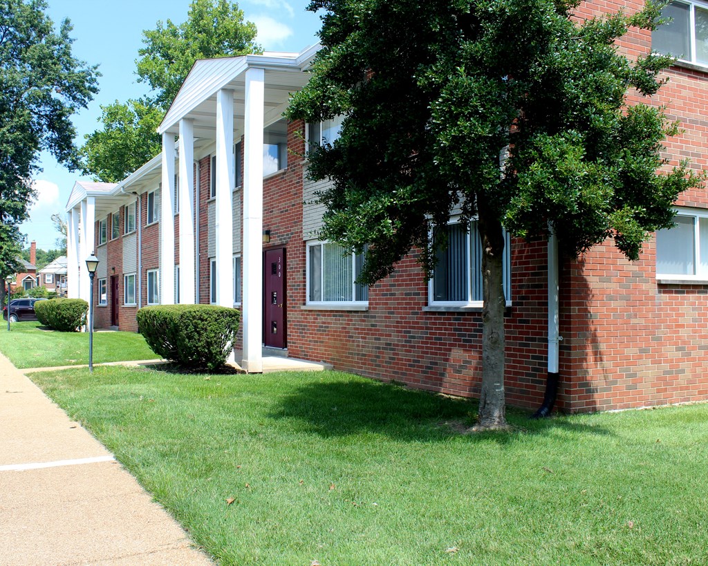 a brick building with a tree in front of it