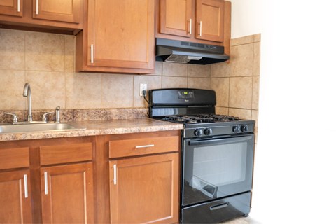 A black stove top oven sits on a kitchen counter.