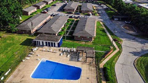 A swimming pool in a residential area surrounded by houses.