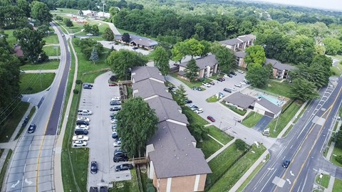 A bird's eye view of a suburban neighborhood with houses and cars.