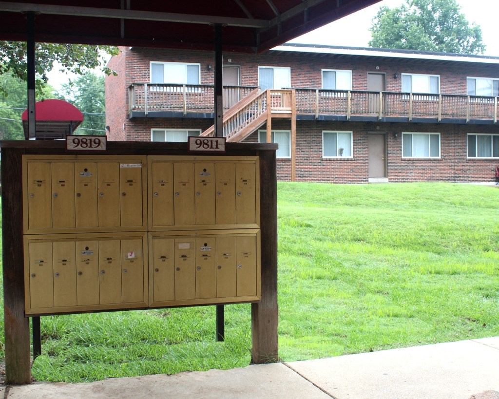 the lockers in front of a building with a mailbox