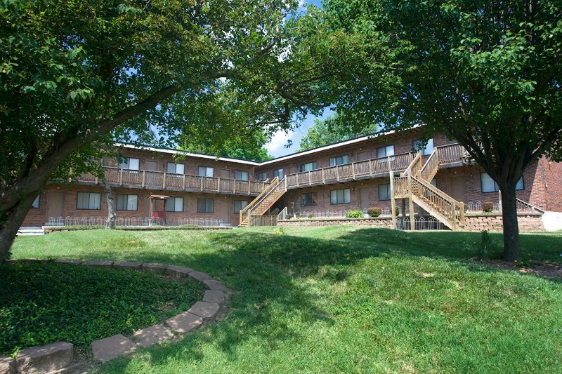an exterior view of an apartment building with stairs