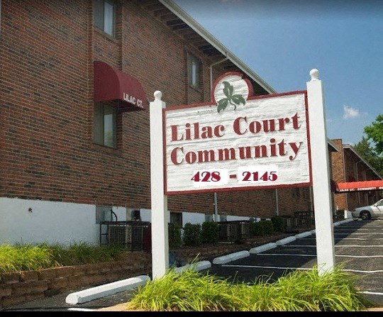 the little court community sign in front of a building