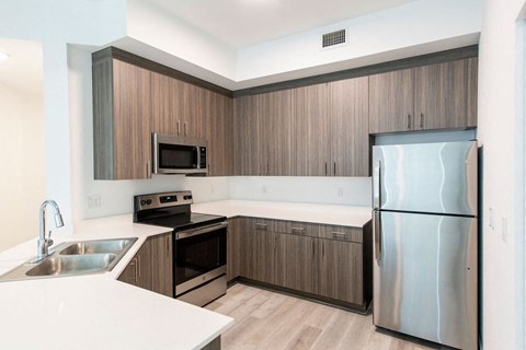 a kitchen with stainless steel appliances and wooden cabinets