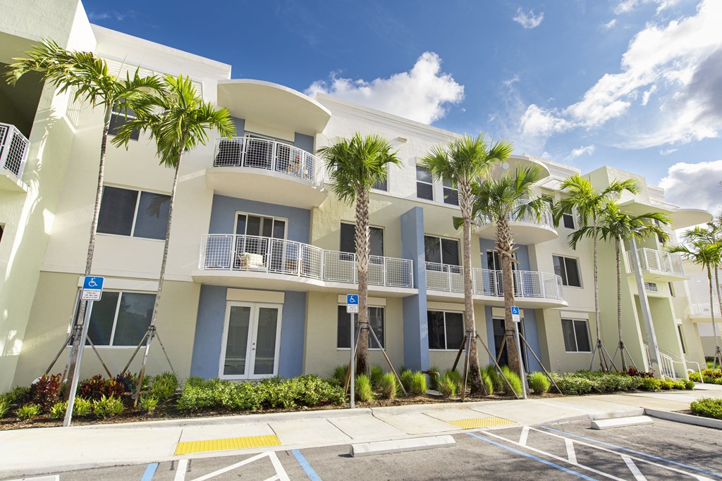 a building with palm trees in front of it