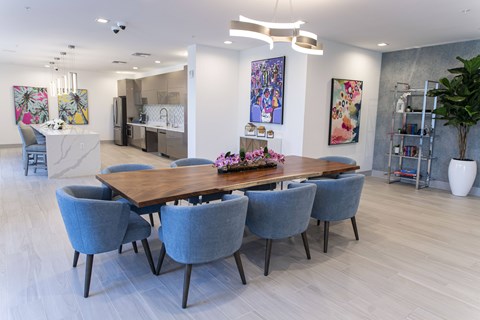 A dining room with a long table and chairs.