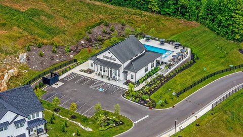A large house with a pool and a driveway.