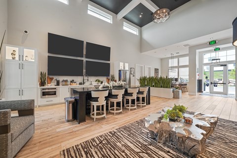 A modern kitchen with a dining table and chairs.