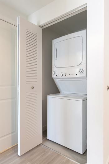A white washing machine and dryer in a small laundry room.