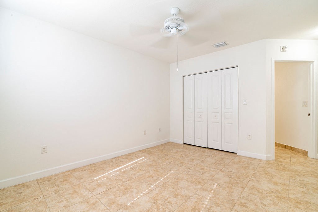 an empty living room with a door to a closet