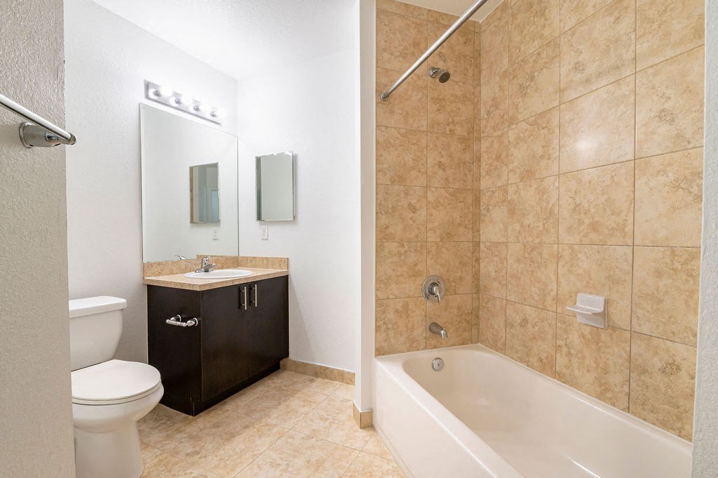 a bathroom with a toilet and a tub and a sink