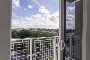 A view from a balcony looking out at a cloudy sky.