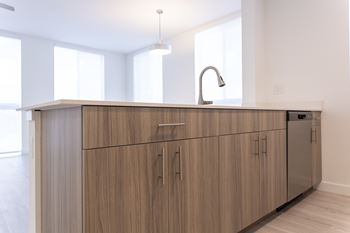 A kitchen with wooden cabinets and a modern design.
