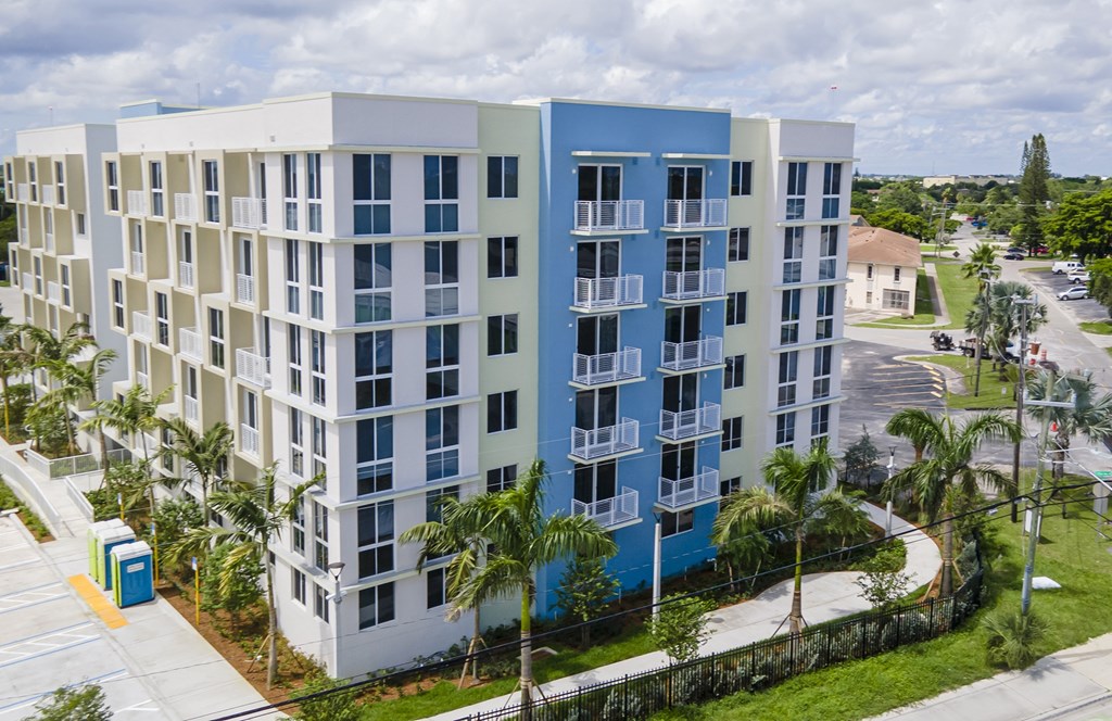 A modern apartment building with blue and white balconies.