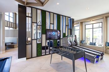 A billiard table in a room with a sign that says "URBAN".