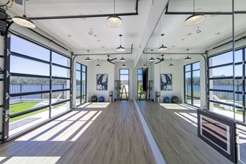 A spacious room with wooden floors and a long white line down the center.