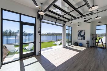A modern house with a balcony overlooking a body of water.