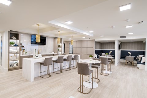 A modern dining area with a bar and seating.