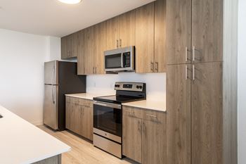a kitchen with wooden cabinets and a stove and a refrigerator