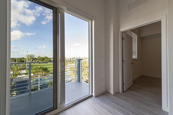 a living room with sliding glass doors and a balcony