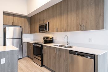 a kitchen with stainless steel appliances and wooden cabinets