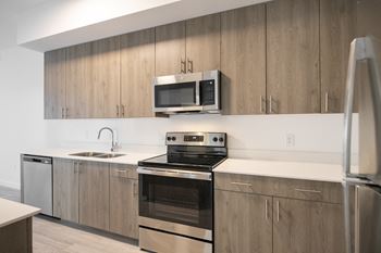 a kitchen with stainless steel appliances and wooden cabinets